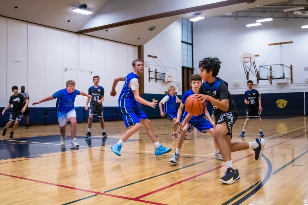 Long Island youth basketball teams competing in an indoor game with players demonstrating teamwork, defense, and player development skills.